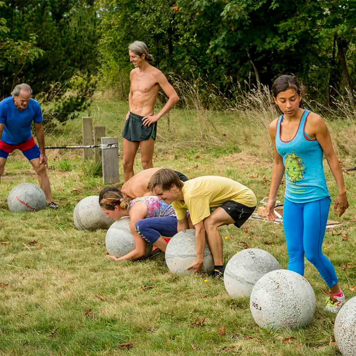 people lifting Atlas 'eggs' at FoodnSport retreats